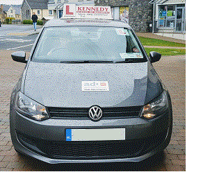 The Kennedy School of Motoring school car parked in Sligo, with the KSM roof sign and Approved Driving Instructor disc displayed.